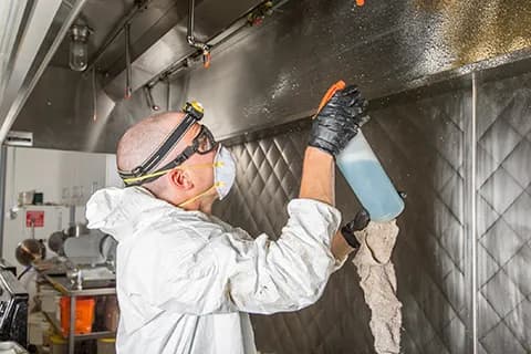 Commercial kitchen with a stainless steel hood system installed in Orange County